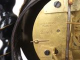 a close up of a clock that is on a table