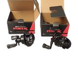 two boxes with two fishing reels in them and one is empty