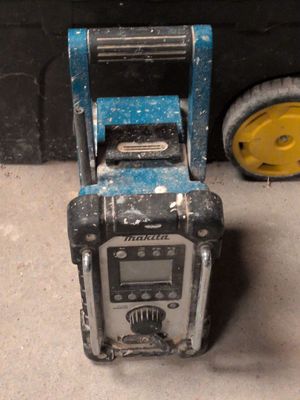 a radio that is sitting on the ground next to a wheel