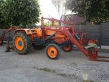 a tractor that is parked next to a fence