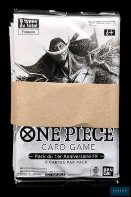 a close up of a box of one piece card game on a black background