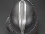a close up of a metal object on a black surface
