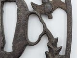 a metal plaque with a bird and a letter d on it