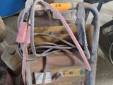 a pile of tools sitting on the ground next to a barrel