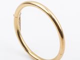 a close up of a gold ring on a white background