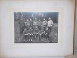 an old black and white photo of a group of people and a dog