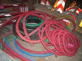 a pile of hoses and other construction equipment on the floor