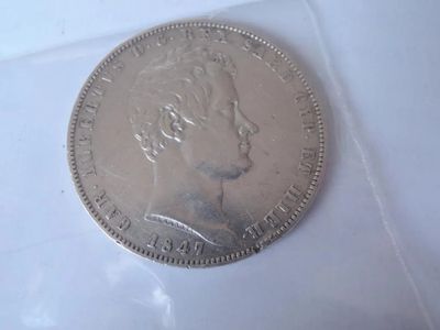 a silver coin with a woman ' s face on it