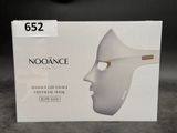 a box with a white mask on it on a table