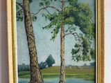 tableau représentant deux arbres au bord d'un lac, dans un cadre doré