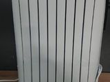 a white radiator sitting on a wooden floor next to a wall