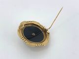 a close up of a gold plated clock with a black face