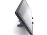 a tablet computer sitting on a stand on a white surface