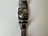 a watch that is hanging on a white wall