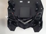 a close up of a black motorcycle seat with wires attached to it
