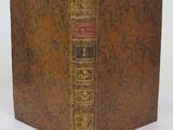 the front cover of a book with a gold and red cover