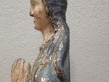 a statue of a woman holding her hands together