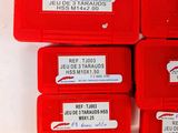 several red boxes with screws and nuts on a white surface