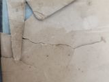 a person holding a pair of scissors near a piece of paper