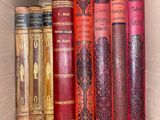 a box full of old books sitting on top of each other