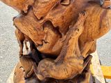 a wooden sculpture of a lion on a wooden bench