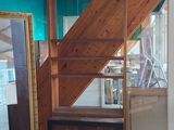 a picture of a room with a staircase and a mirror on the wall