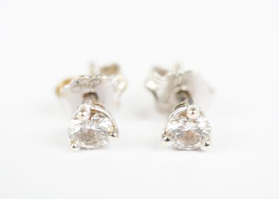 pair of diamond stud earrings on white background