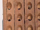a wooden wine rack with a bunch of bottles on it