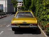 a yellow car that is parked on the side of the road