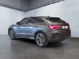 the rear end of a grey suv parked in a garage