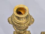 pair of antique brass candlesticks on a white background