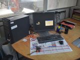 a desk with a computer and a keyboard on it