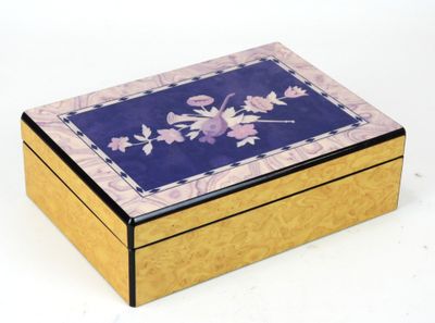 a wooden box with a floral design on it