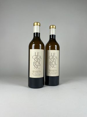 two bottles of wine sitting next to each other on a table