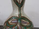 a vase that is sitting on a table next to a vase