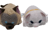 two stuffed animals sitting next to each other on a white surface