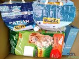 many bags of cat food sitting in a cardboard box