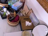 a picture of a cluttered bathroom with various items on the counter