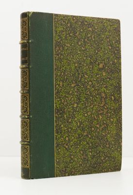 a green book sitting on top of a white table next to a white wall