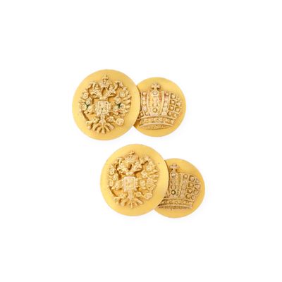 a close up of three gold buttons with a crown on them