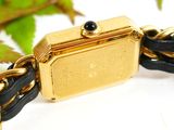 a black and gold bracelet with a gold plated watch on it