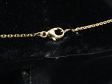 a close up of a black hat with a gold chain on it