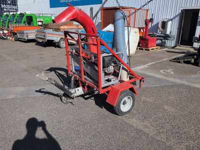 a small red machine that is parked in a parking lot