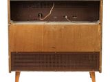 an old radio sitting on top of a wooden cabinet