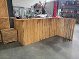a large wooden counter in a warehouse with lots of shelves