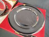 a silver plate that is sitting on a red box