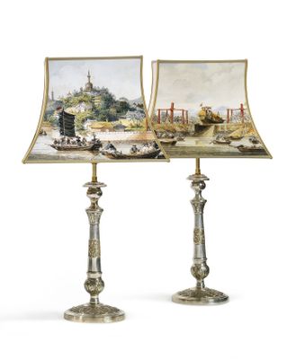 two lamps with pictures of boats on them sitting on top of a table