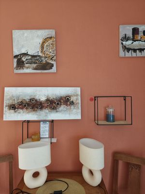 a room with a table, chairs, and pictures on the wall