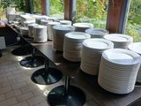 a long table with many plates on it in a restaurant