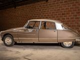 a brown car parked in a garage next to a brick wall